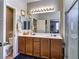 Bathroom featuring double sinks, a large mirror, and a glass-enclosed shower at 8036 Literature Ct, Las Vegas, NV 89113