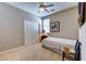 Bedroom features neutral walls, carpet, ceiling fan, and closet with sliding doors at 8036 Literature Ct, Las Vegas, NV 89113