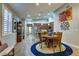 Bright dining area with wood-look floors, adjacent to the kitchen and living spaces at 8036 Literature Ct, Las Vegas, NV 89113