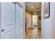 Hallway with wood-look flooring, closet, and views into laundry and bedroom at 8036 Literature Ct, Las Vegas, NV 89113