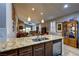 Open kitchen with granite counters, stainless appliances, and adjacent to the living area at 8036 Literature Ct, Las Vegas, NV 89113