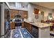 Modern kitchen with stainless steel appliances, granite countertops, and warm wood cabinets at 8036 Literature Ct, Las Vegas, NV 89113