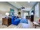 Inviting living room with a comfortable blue sectional and stylish decor with lots of light at 8036 Literature Ct, Las Vegas, NV 89113