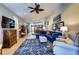 Spacious living room features recessed lighting, a ceiling fan, stylish furniture and an open floor plan at 8036 Literature Ct, Las Vegas, NV 89113