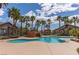 Community pool featuring palm trees, waterfall feature, and a gazebo, offering a resort-like experience at 8250 N Grand Canyon Dr # 1084, Las Vegas, NV 89166