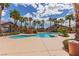 Community pool featuring palm trees, waterfall feature, and a gazebo, offering a resort-like experience at 8250 N Grand Canyon Dr # 1084, Las Vegas, NV 89166