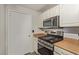 Modern kitchen features stainless steel gas range and microwave, complemented by warm countertops at 8250 N Grand Canyon Dr # 1084, Las Vegas, NV 89166