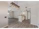 Open living space with modern lighting fixtures, transitioning to the dining area and kitchen at 8250 N Grand Canyon Dr # 1084, Las Vegas, NV 89166