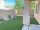 This backyard features artificial turf and block wall fencing at 8374 Pioneer Way, Las Vegas, NV 89113