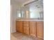 Bright bathroom featuring a double sink vanity with cabinets and a large mirror at 8374 Pioneer Way, Las Vegas, NV 89113