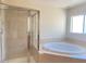 Luxurious bathroom featuring a walk-in shower and a large soaking tub at 8374 Pioneer Way, Las Vegas, NV 89113
