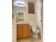 Compact bathroom featuring a vanity, mirror, and toilet, designed for functionality at 8374 Pioneer Way, Las Vegas, NV 89113