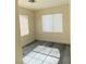 Bright bedroom with modern gray flooring and natural light from two windows at 8374 Pioneer Way, Las Vegas, NV 89113