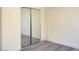 This bedroom features light gray flooring and a mirrored sliding door closet at 8374 Pioneer Way, Las Vegas, NV 89113