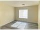 Bright bedroom with modern gray flooring, white trim, and ample natural light at 8374 Pioneer Way, Las Vegas, NV 89113
