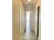 Hallway with laminate floors and white doors at 8374 Pioneer Way, Las Vegas, NV 89113