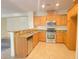 Bright kitchen with stainless steel appliances and a breakfast bar with granite countertops at 8374 Pioneer Way, Las Vegas, NV 89113