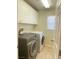 Convenient laundry room with modern Samsung washer and dryer and storage cabinets at 8374 Pioneer Way, Las Vegas, NV 89113