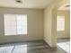 Spacious living room with gray flooring and two windows to allow for natural lighting at 8374 Pioneer Way, Las Vegas, NV 89113