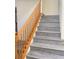 Stairway featuring modern wood-look steps and a classic wooden handrail at 8374 Pioneer Way, Las Vegas, NV 89113