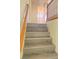 Stairway featuring modern wood-look steps and a classic wooden handrail at 8374 Pioneer Way, Las Vegas, NV 89113