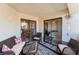 Charming outdoor balcony featuring comfortable seating and sliding glass doors to indoor spaces at 8455 W Sahara Ave # 287, Las Vegas, NV 89117