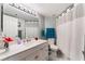 Bright bathroom with a white vanity, modern lighting, and a shower with white curtains at 8455 W Sahara Ave # 287, Las Vegas, NV 89117