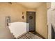 Condo entryway featuring a gray door with a decorative wreath, ensuring a warm welcome for residents at 8455 W Sahara Ave # 287, Las Vegas, NV 89117