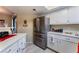 Kitchen features a stainless steel refrigerator and white cabinets at 8455 W Sahara Ave # 287, Las Vegas, NV 89117