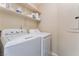 A convenient laundry area equipped with a washer, a dryer, and built-in shelving at 8455 W Sahara Ave # 287, Las Vegas, NV 89117