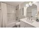 Well-lit bathroom featuring a shower-tub combo and modern vanity with sleek fixtures at 8513 Glenmount Dr, Las Vegas, NV 89134