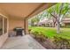 View of the cozy covered patio with BBQ, landscaping and mature shade trees at 8513 Glenmount Dr, Las Vegas, NV 89134