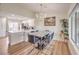 Open dining area adjacent to kitchen with views of backyard from windows and light from modern chandelier at 8513 Glenmount Dr, Las Vegas, NV 89134