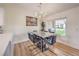 Bright dining area features a modern chandelier, sleek marble table, and views of the lush outdoor space at 8513 Glenmount Dr, Las Vegas, NV 89134