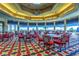 A charming dining area with lots of natural light and tables with red, white, and black chairs at 8513 Glenmount Dr, Las Vegas, NV 89134