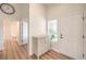Bright entryway with hardwood floors, white walls, modern cabinet, and direct access to the living spaces at 8513 Glenmount Dr, Las Vegas, NV 89134