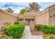 Home's entryway features a secure gate, desert landscaping, and a covered entrance leading to the front door at 8513 Glenmount Dr, Las Vegas, NV 89134