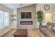 Living room with modern fireplace, wall decor, and hardwood floors at 8513 Glenmount Dr, Las Vegas, NV 89134