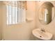 Small bathroom featuring a decorative mirror, vanity, and natural light at 8861 Hampton Green Ave, Las Vegas, NV 89129