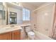 Bathroom featuring a bright mirror, a light color palette, and a shower-tub combo at 8861 Hampton Green Ave, Las Vegas, NV 89129