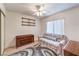 Small bedroom with soft colorful rug, soft light, large window and an overhead fan at 8861 Hampton Green Ave, Las Vegas, NV 89129