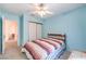Bright bedroom featuring a light color palette, a ceiling fan, and a large closet at 8861 Hampton Green Ave, Las Vegas, NV 89129