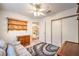 Bedroom featuring soft colorful rug, soft light, large window and an overhead fan at 8861 Hampton Green Ave, Las Vegas, NV 89129