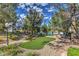 Community park featuring lush landscaping, mature trees, and a picnic area at 8861 Hampton Green Ave, Las Vegas, NV 89129