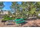 Community park featuring a barbecue, picnic tables, lush greenery, and mature trees at 8861 Hampton Green Ave, Las Vegas, NV 89129