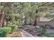 Picturesque community park with picnic tables, walking paths, mature trees and manicured landscaping at 8861 Hampton Green Ave, Las Vegas, NV 89129