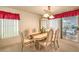 Bright dining room with a chandelier, and sliding glass doors to the patio at 8861 Hampton Green Ave, Las Vegas, NV 89129