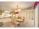 Bright dining room with a chandelier, and view into the kitchen at 8861 Hampton Green Ave, Las Vegas, NV 89129