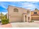 Two-story home featuring a two-car garage, concrete driveway, and low-maintenance desert landscaping at 8861 Hampton Green Ave, Las Vegas, NV 89129