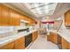Spacious kitchen with light wood cabinetry, tile countertops, and stainless steel appliances at 8861 Hampton Green Ave, Las Vegas, NV 89129